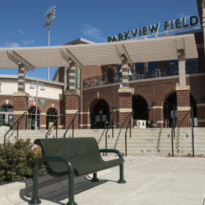 Green Wabash Valley bench in front of Parkview Field with a clear blue sky